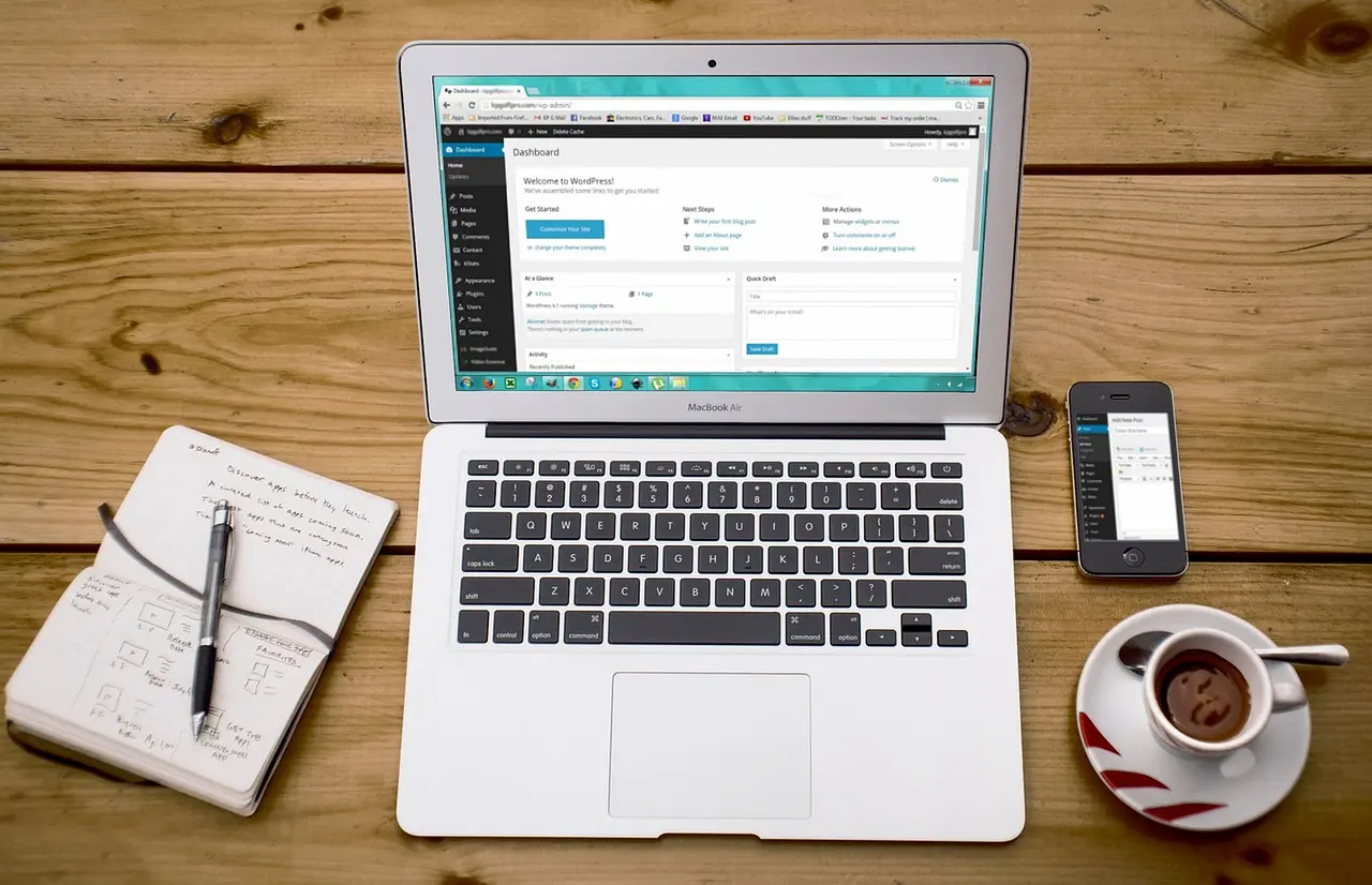 A laptop and a smartphone side by side on a desk