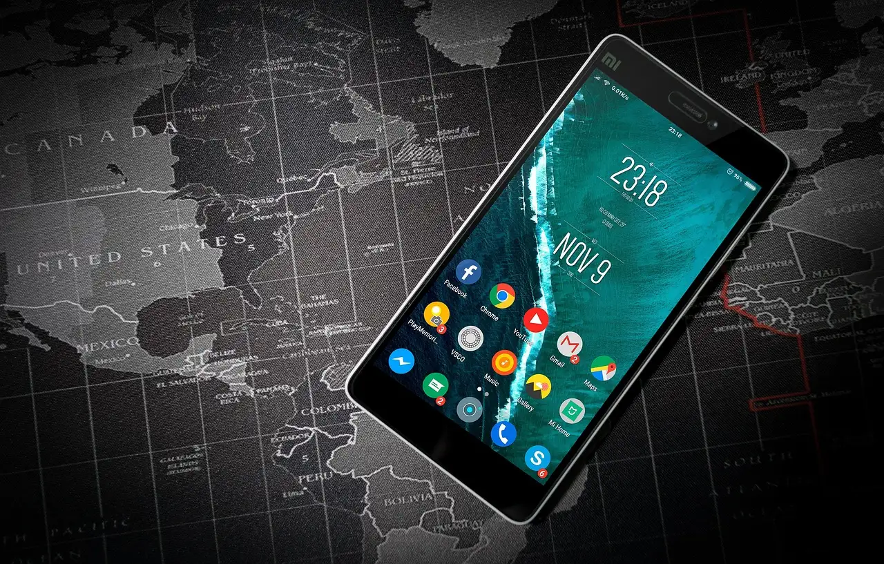A Xiaomi Android phone resting on a gray world map, home screen showing colorful app icons