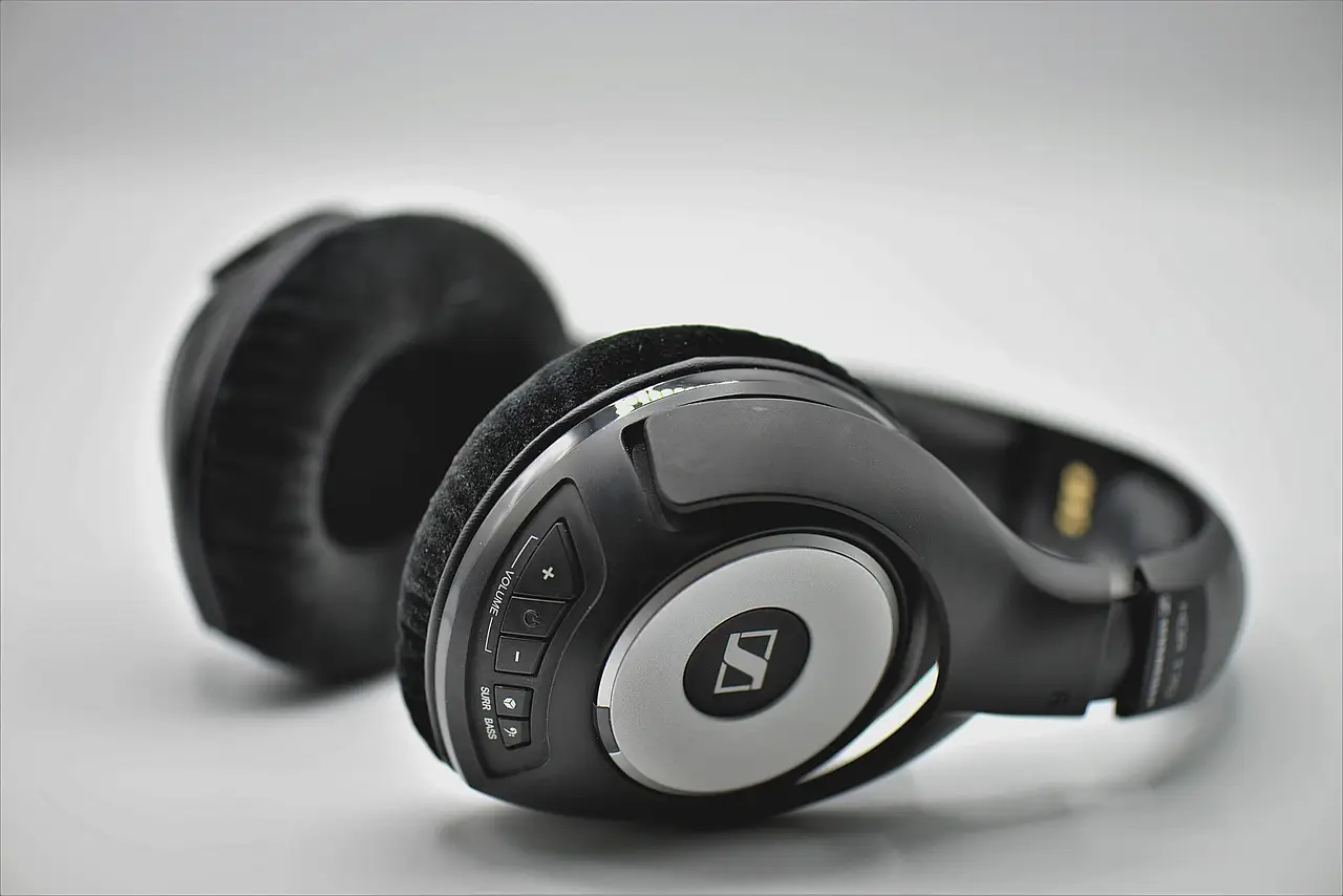 A pair of wireless over-ear headphones on a plain surface