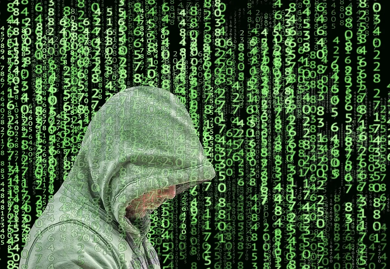 A person typing on a laptop at a kitchen table with a small security shield icon glowing faintly on the screen.
