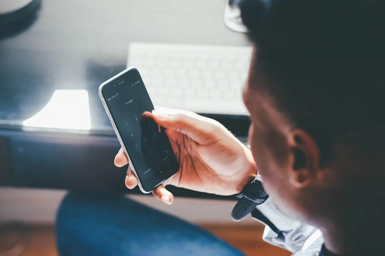 A finger touching a smartphone screen.