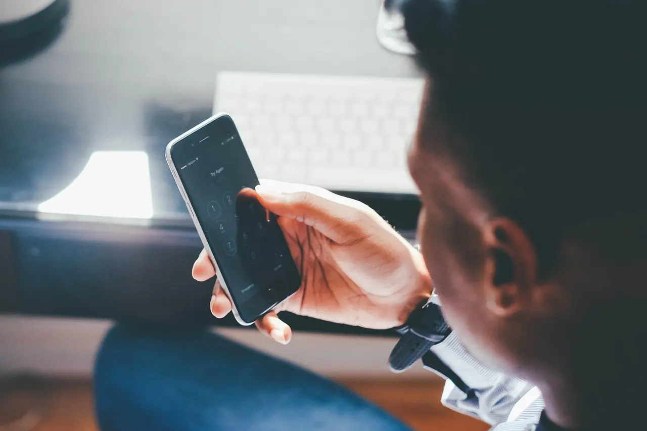 A finger touching a smartphone screen.