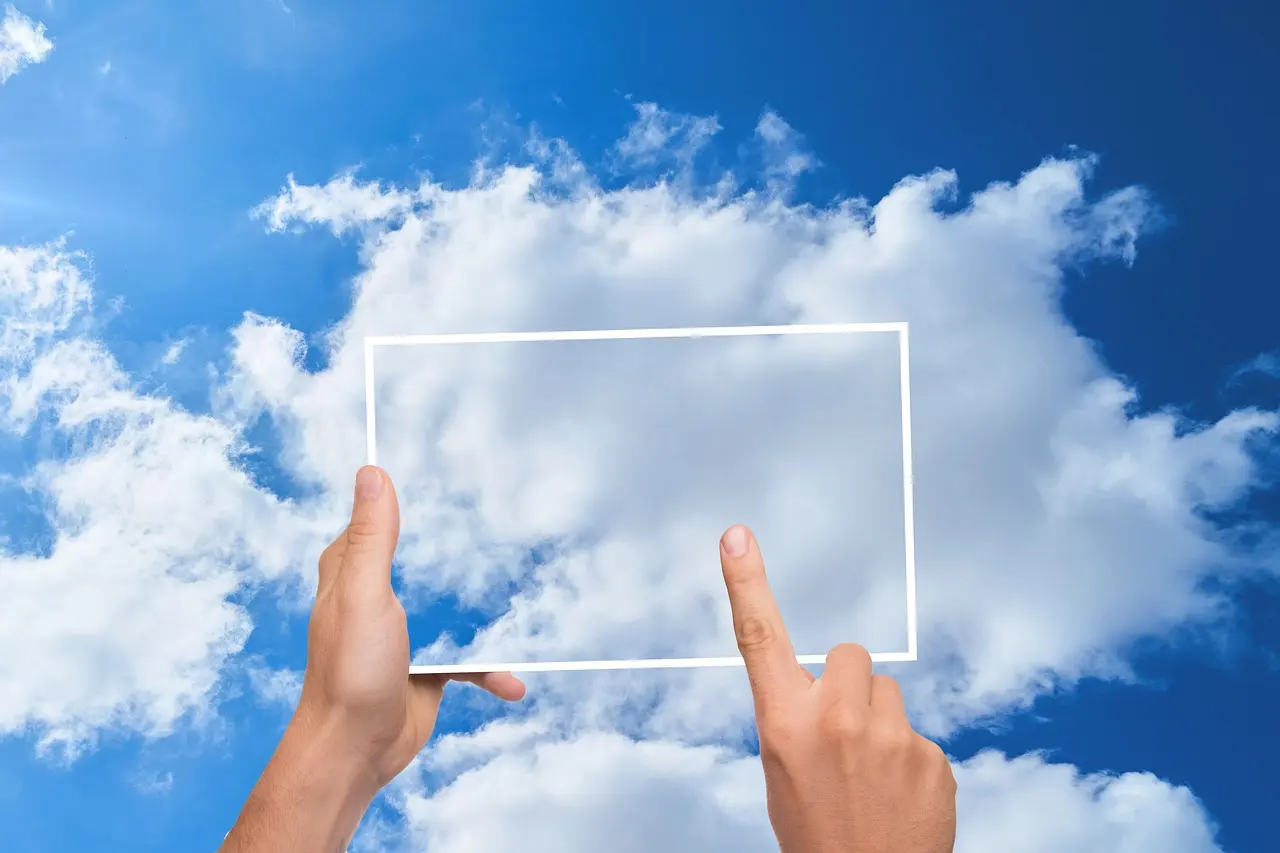 A finger tapping a cloud storage icon on a tablet