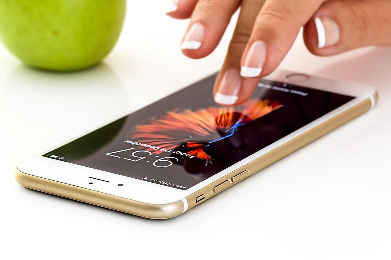 A hand using a smartphone touchscreen