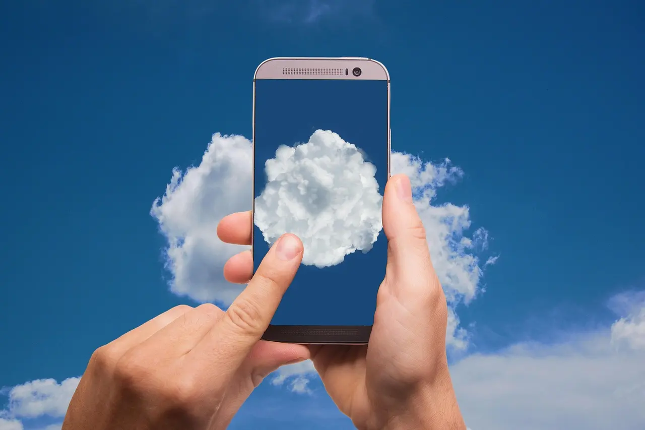 A finger tapping a cloud icon on a smartphone