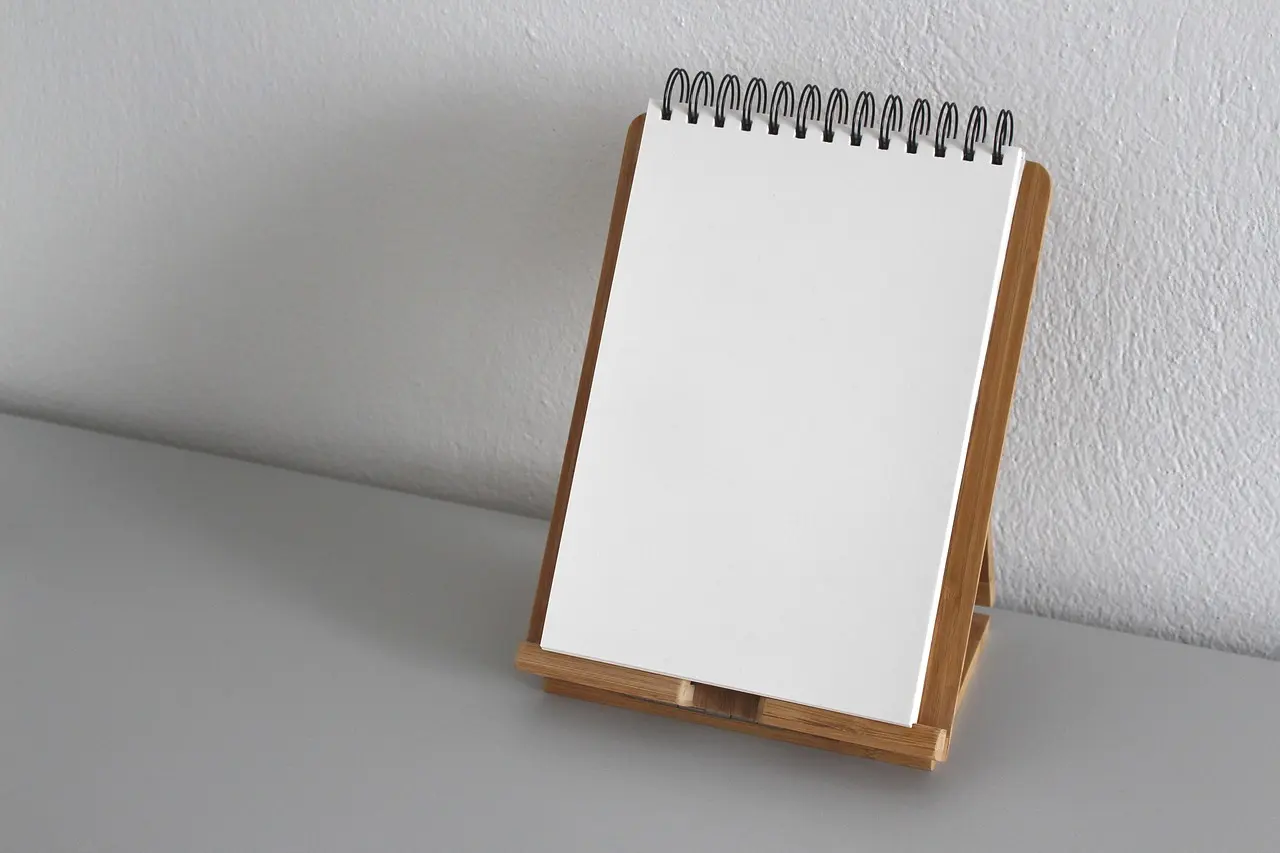 A blank sheet of paper in a notebook