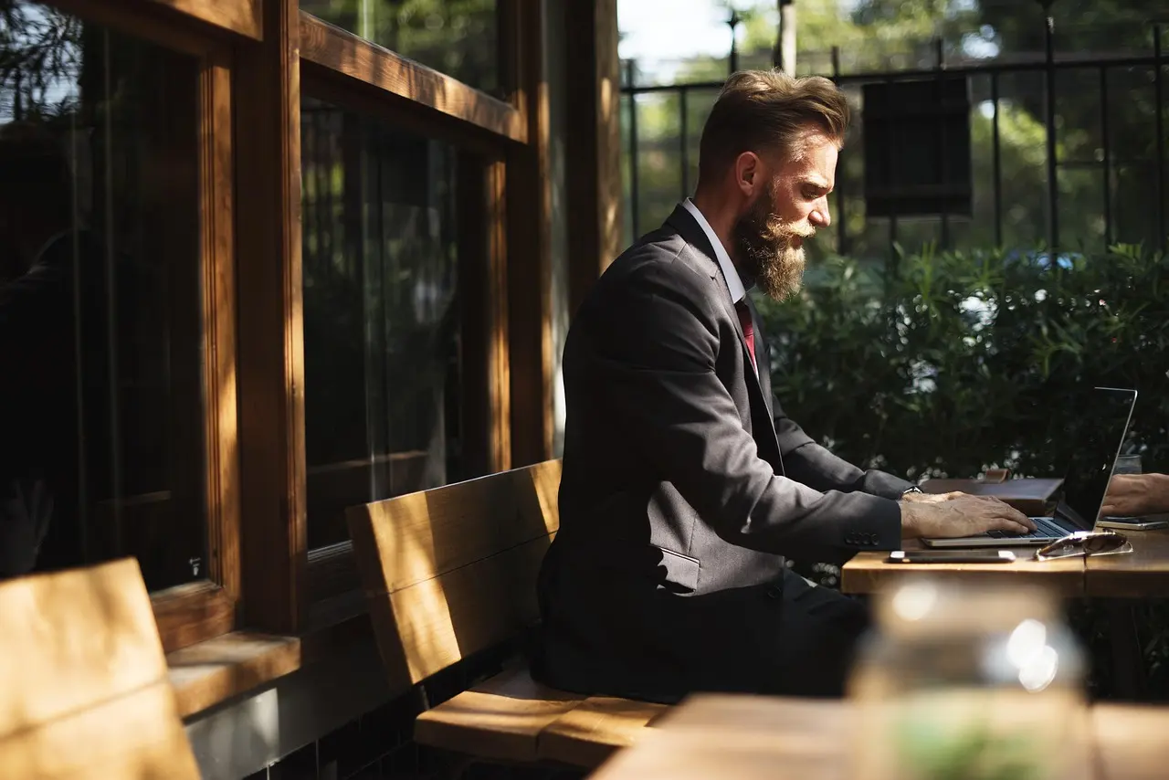 A person working on a laptop in a cafe