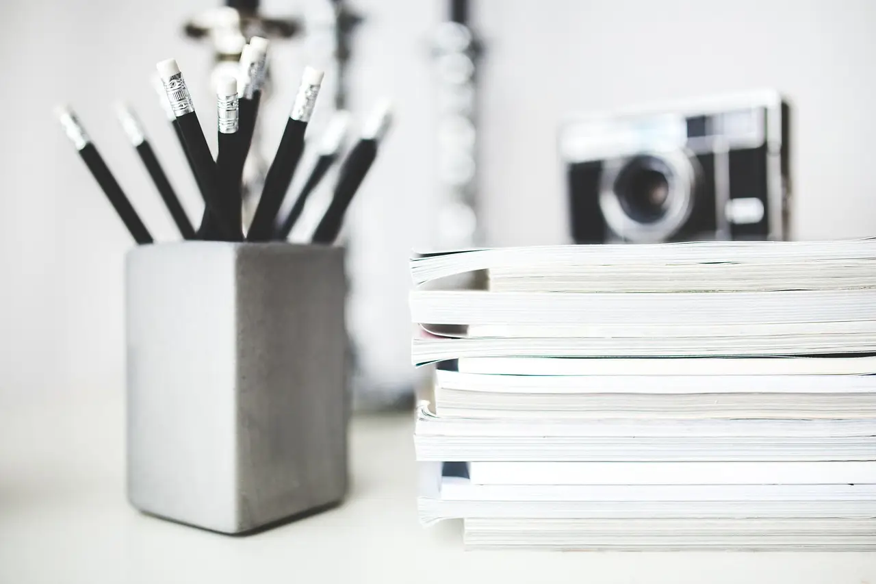 A tidy stack of notebooks and pencils on a desk