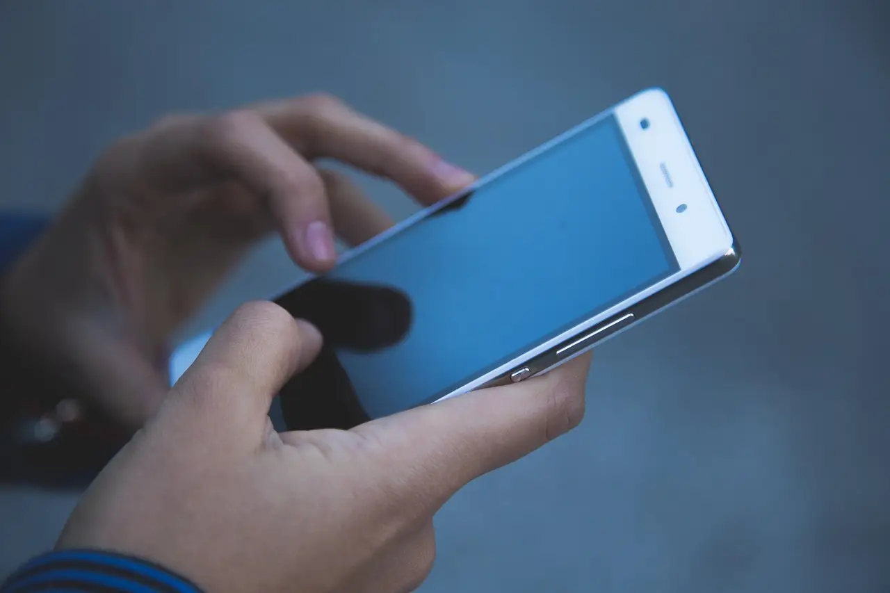 A person holding a smartphone in both hands.