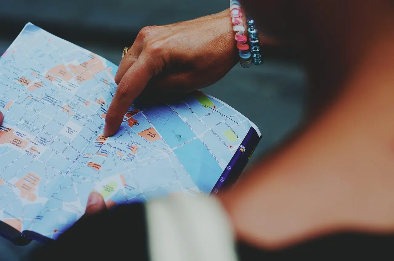 A world map with markers, illustrating locating a place