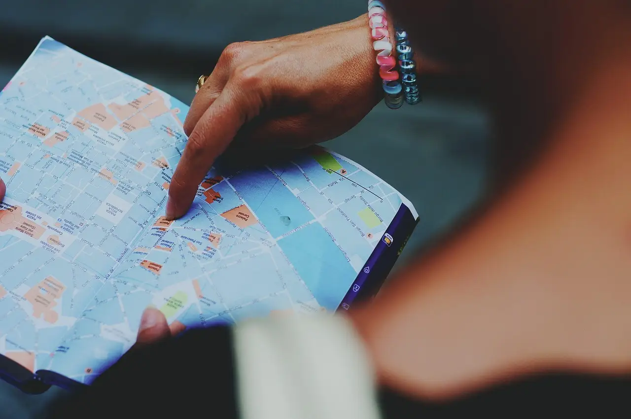 A world map with markers, illustrating locating a place
