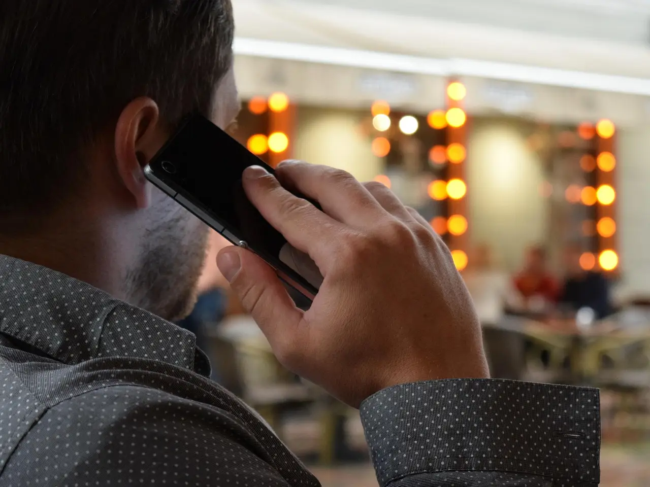 A person holding a smartphone in one hand