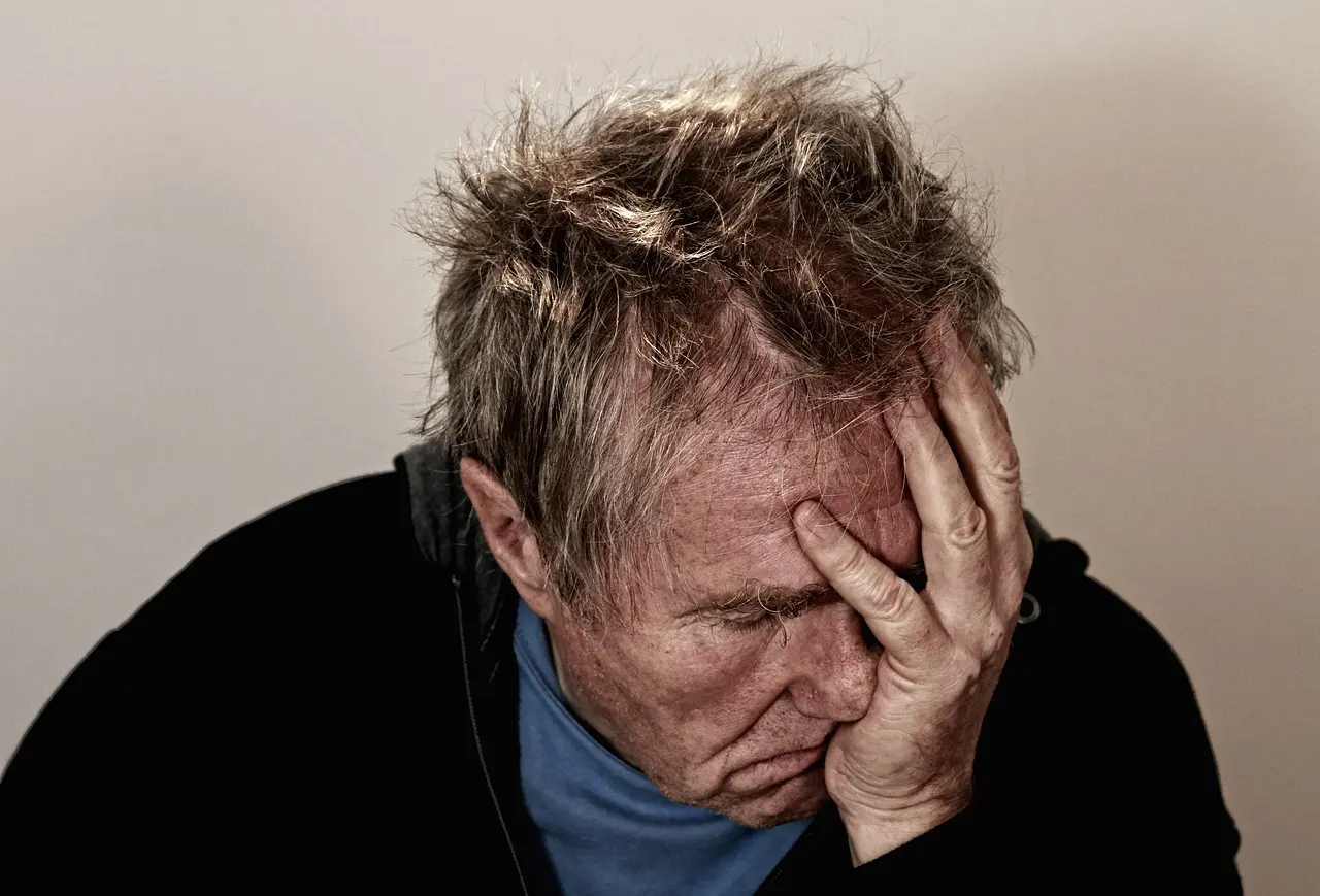 A frustrated older man at a desk