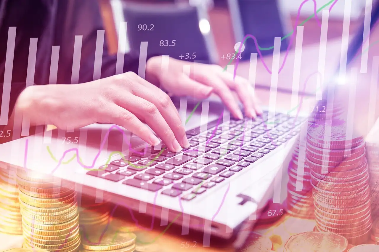 Hands typing on a laptop keyboard