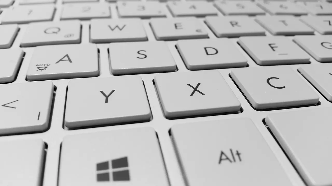 Close-up of a white laptop keyboard with the Windows key and Alt key in the foreground