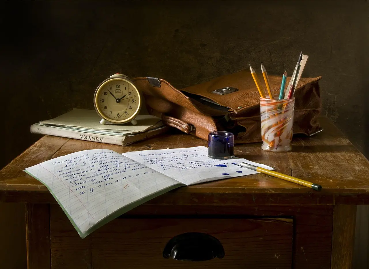 A student's written assignment and school supplies