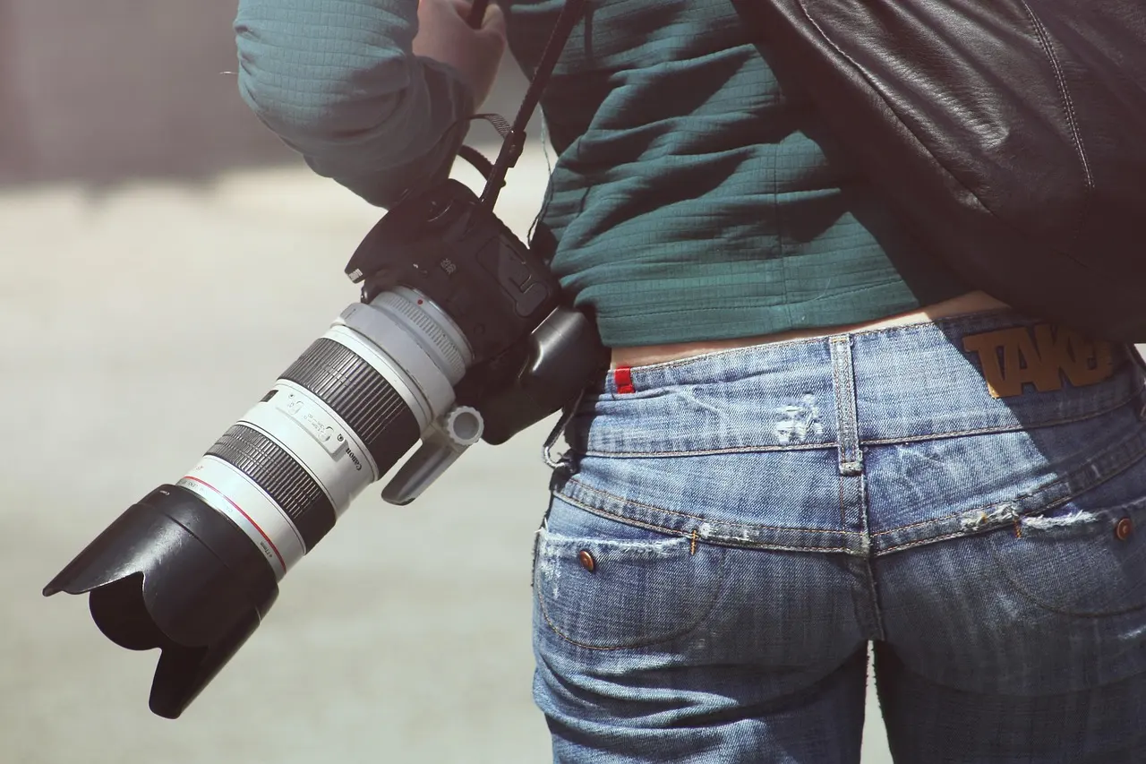 A photographer holding a digital camera