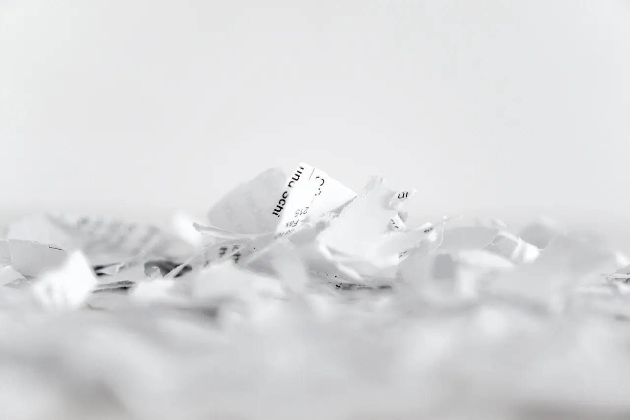 A paper shredder cutting sheets into strips