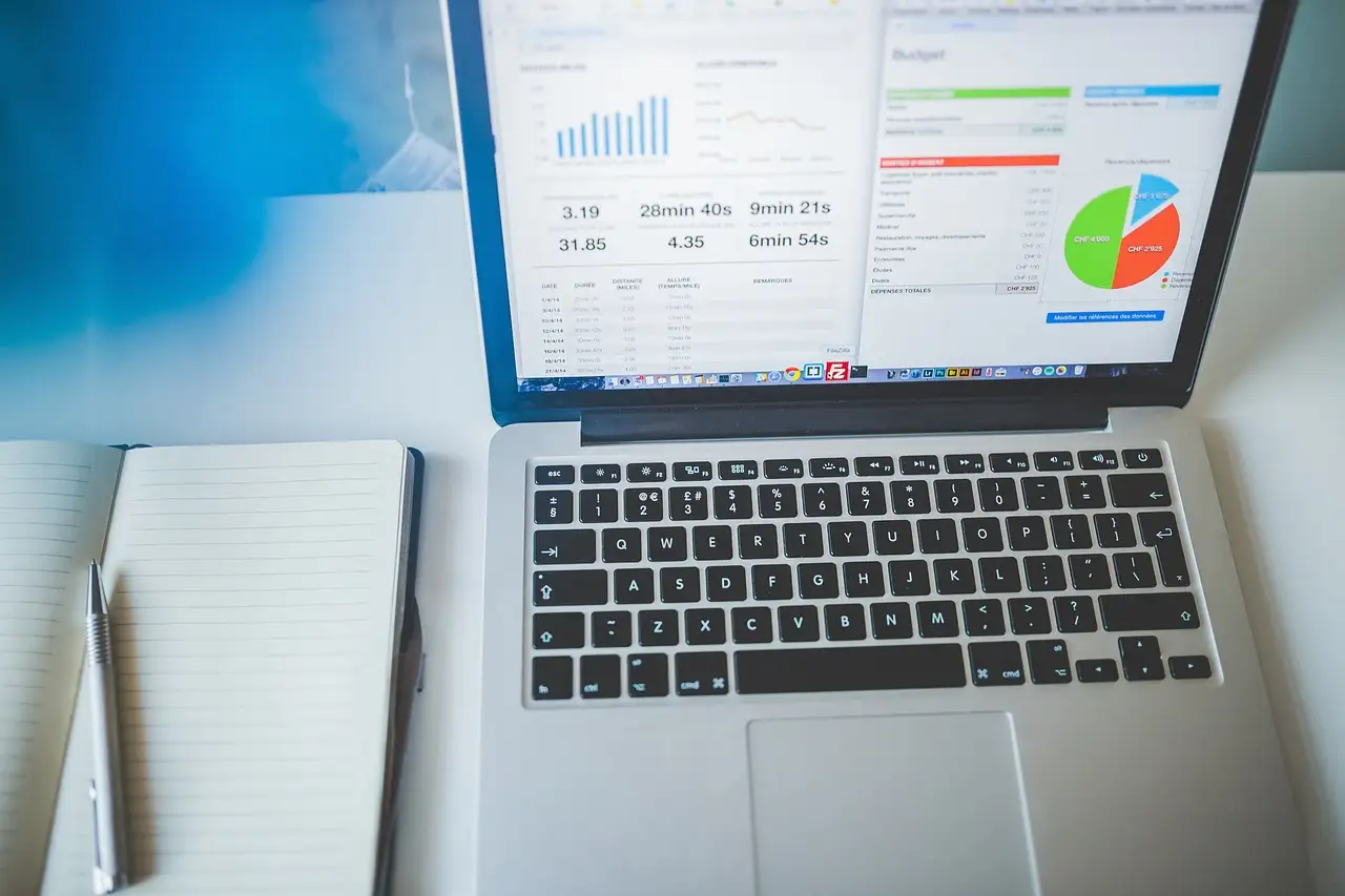 A laptop showing business charts on a desk